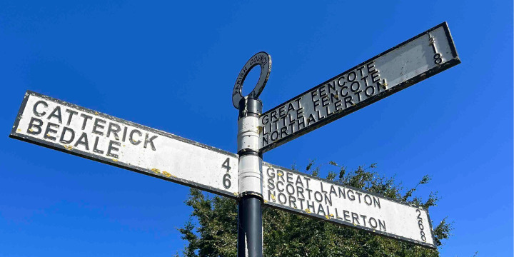 Signpost on The Green in the village of Kirkby Fleetham